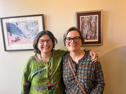 Andrea Lawson and Darby Smith in front of the artwork